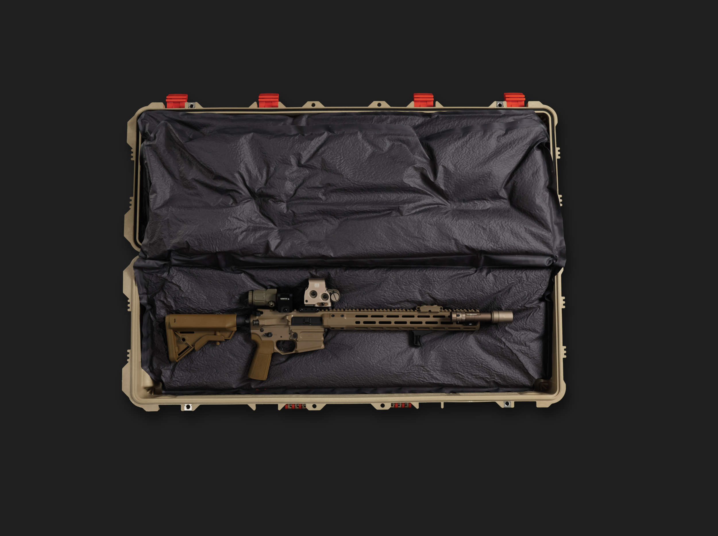 A tan tactical rifle case open with a tan semi-automatic rifle inside, padded with black foam lining.