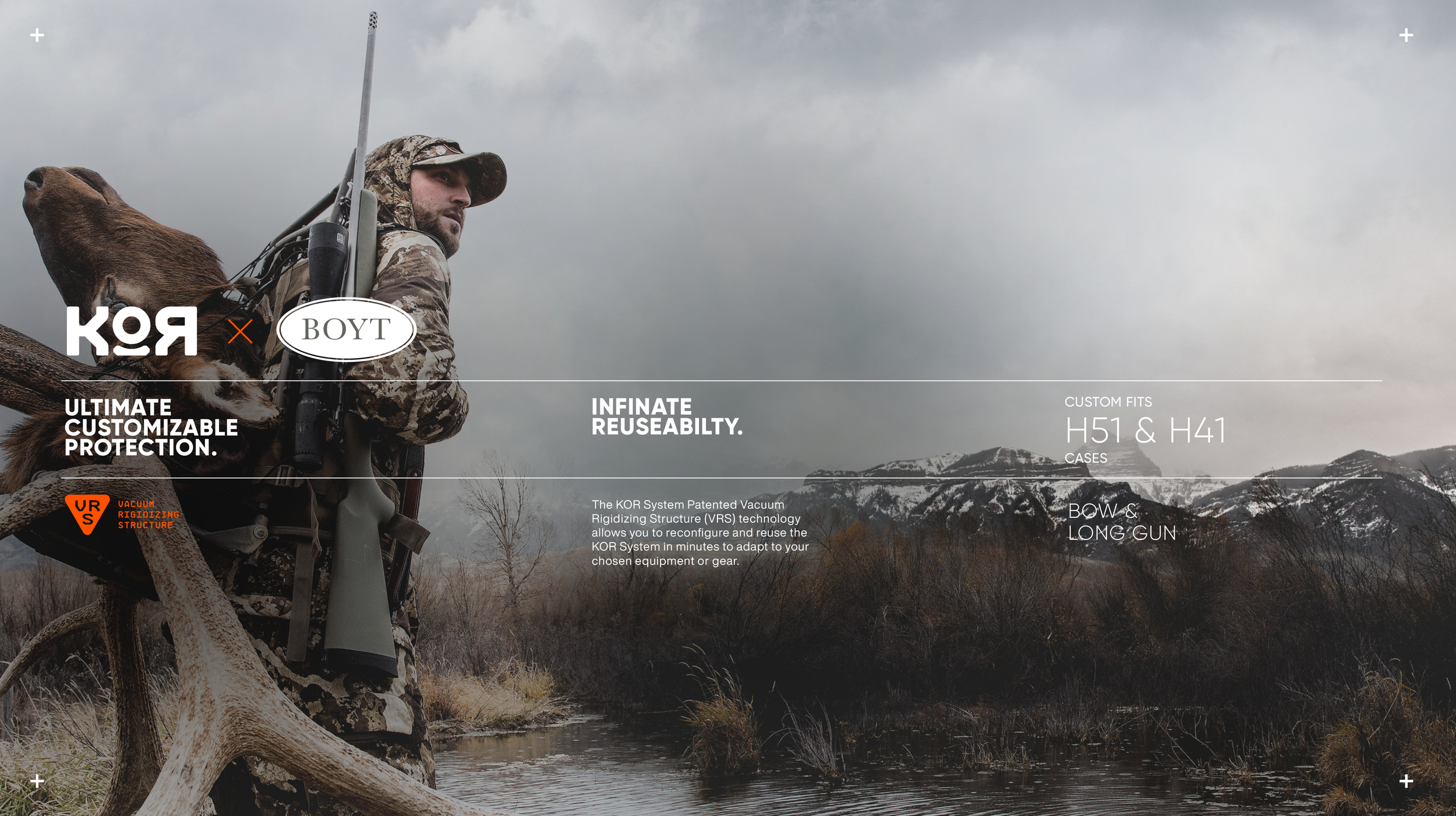 A hunter dressed in camouflage gear stands outdoors near a river, holding a rifle on his shoulder, with a deer lying in the foreground and a mountainous landscape in the background.