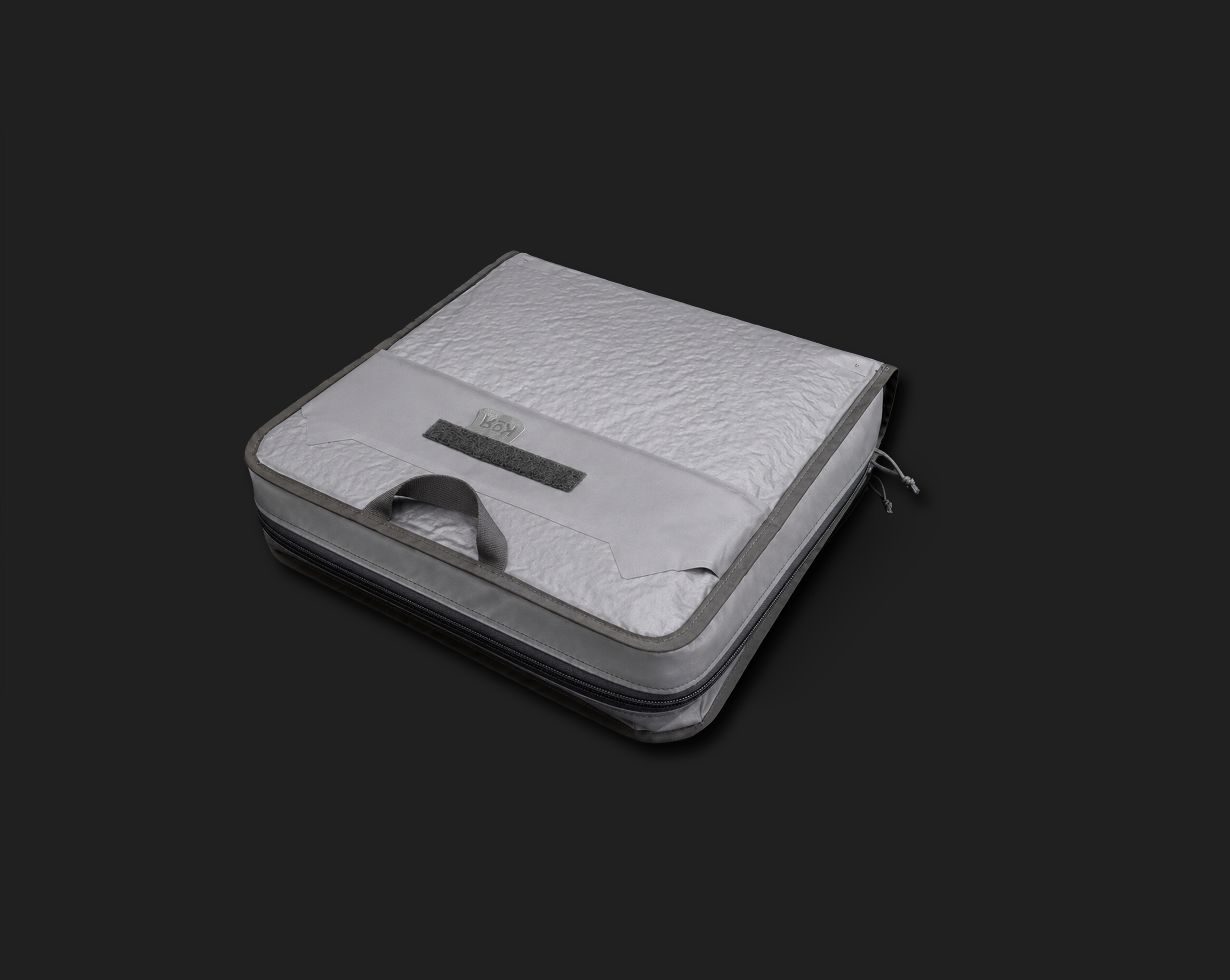 A white portable cooler with a textured surface bands and a gray handle, sitting on a black background.