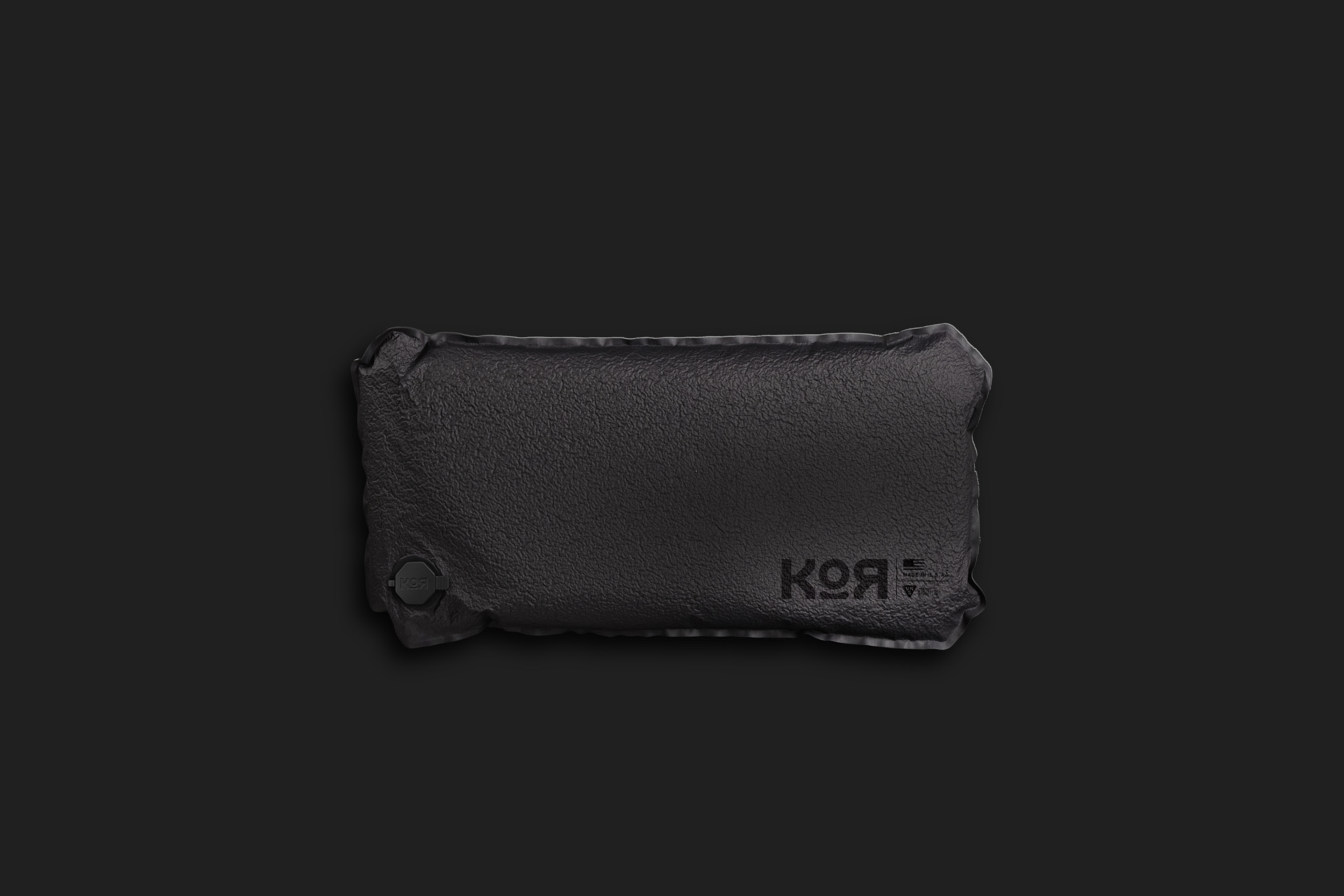 A black textured bag with the brand name 'KOR' printed on it, set against a black background.