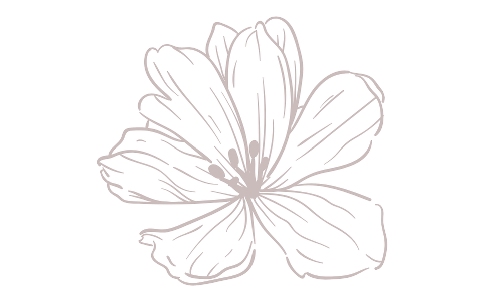 Soft-toned flowers arranged with gifts and jewellery