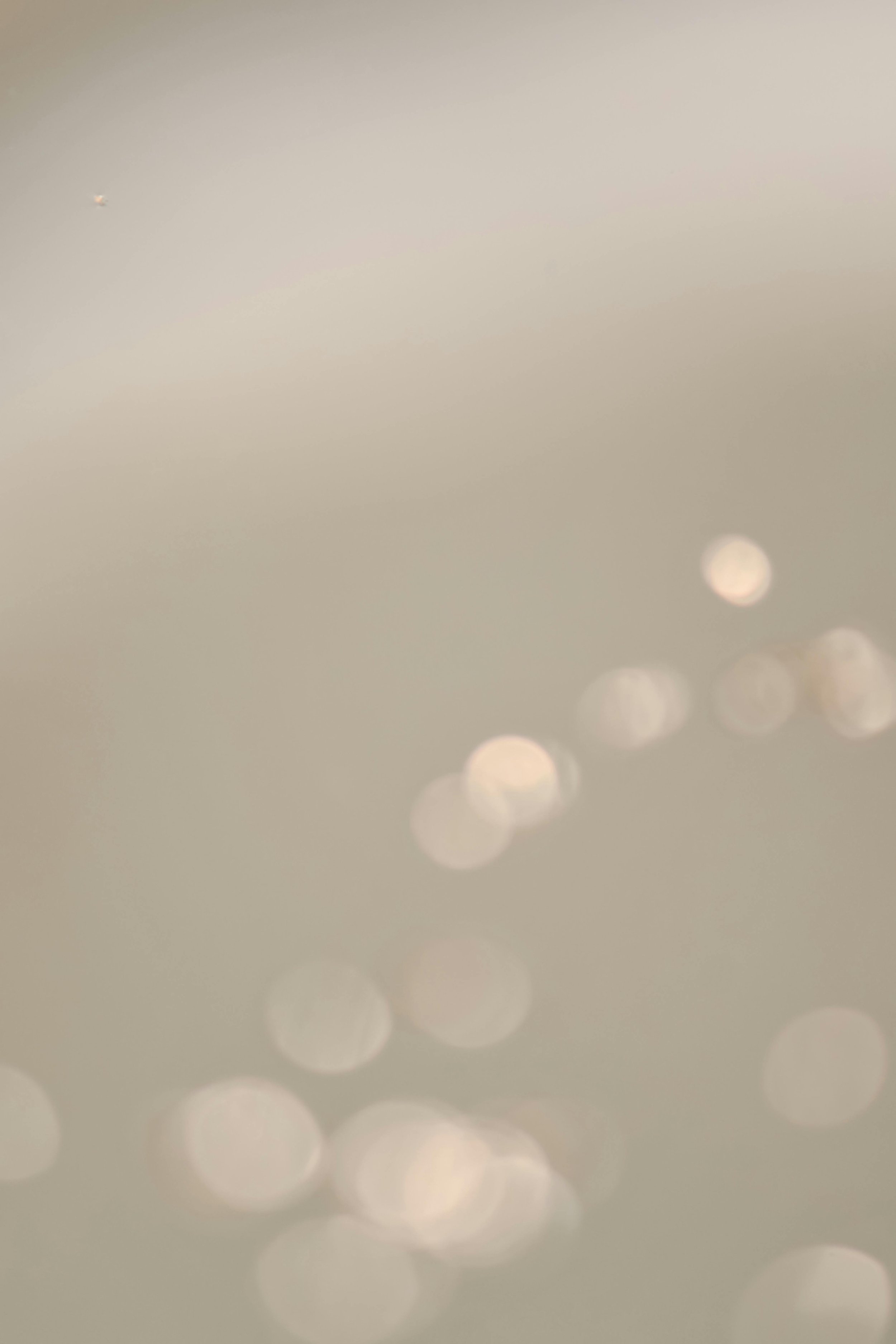 Blurred image with light bokeh effect, no distinct objects or details visible.