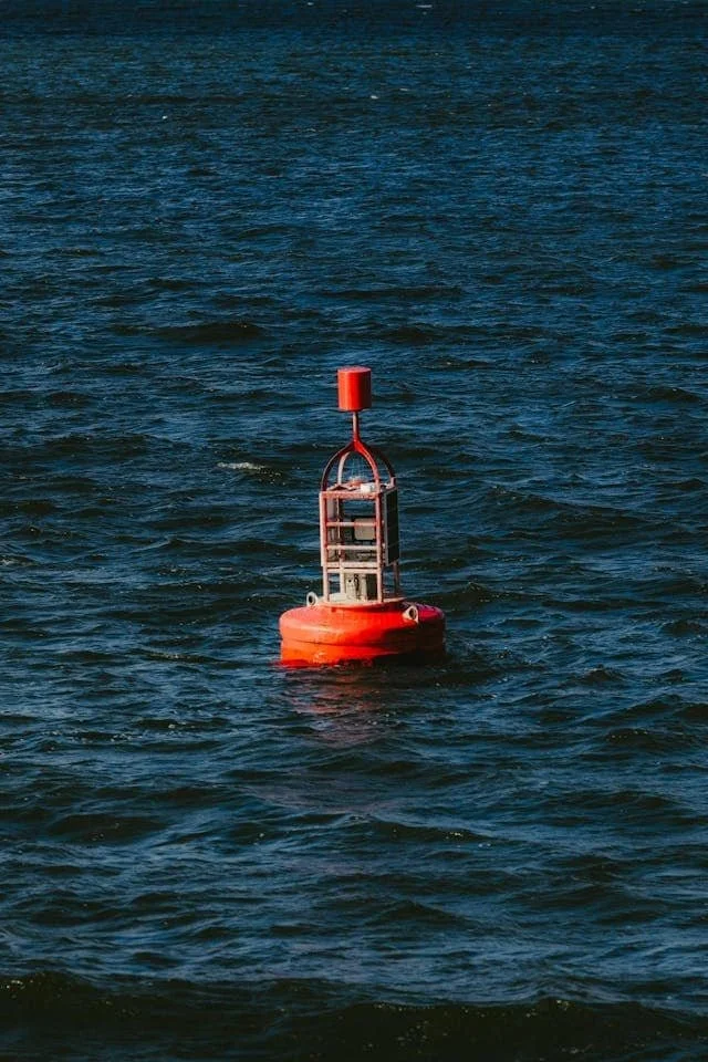orange buoy floating in ocean