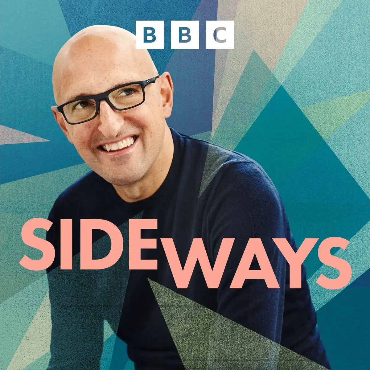 A smiling man wearing black glasses against a geometric, abstract, blue-green background with the BBC logo and the title 'Sideways' in pink text.