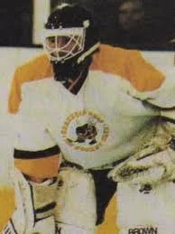 Ice hockey goalkeeper in full gear on ice rink
