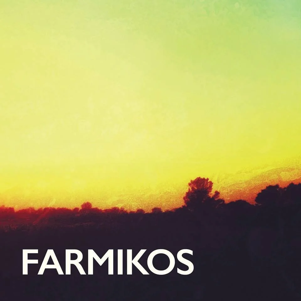 A landscape at sunset with dark silhouette trees and a vibrant yellow sky. The word "FARMIKOS" is displayed at the bottom.