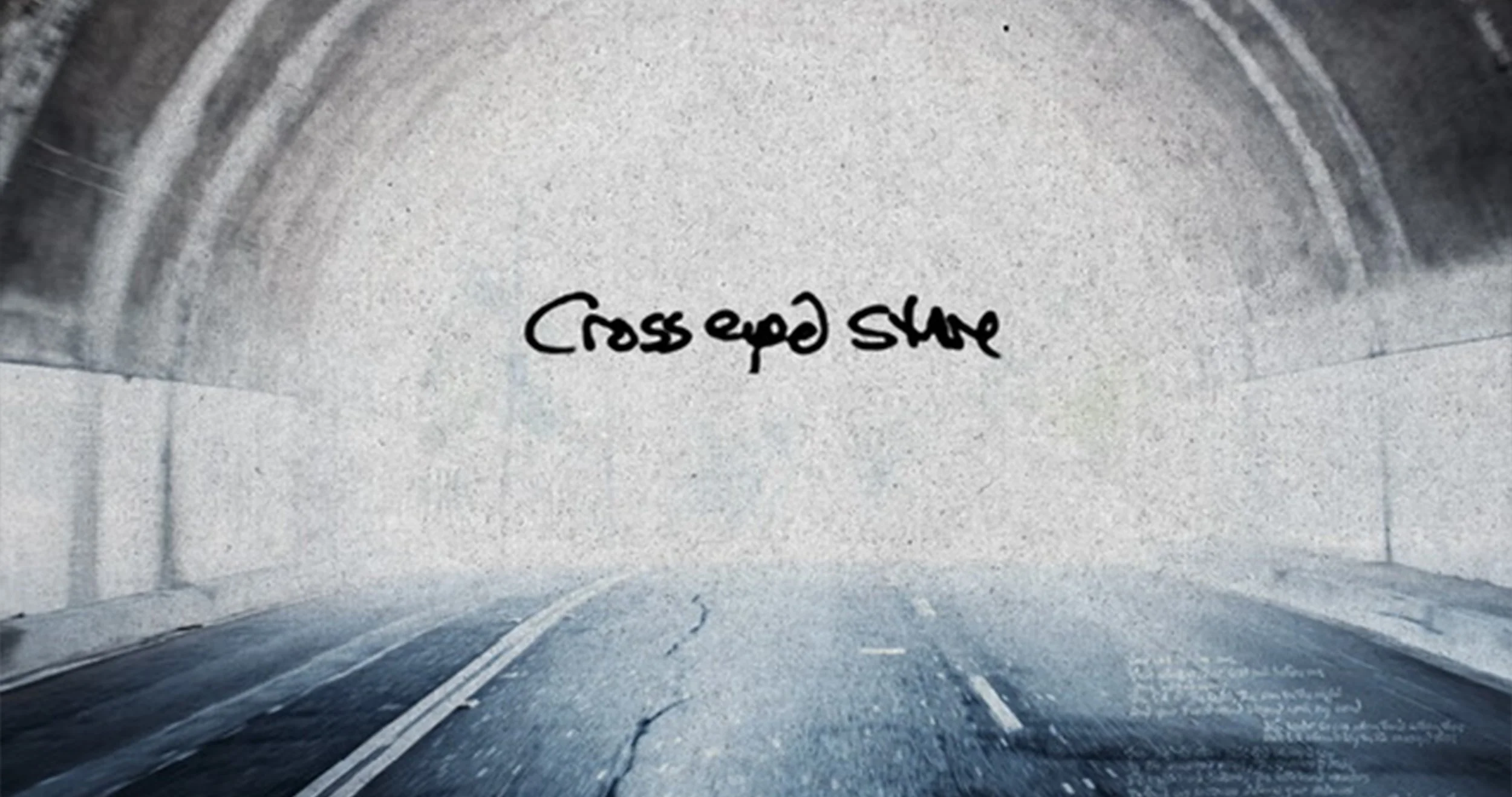 A view of a tunnel with the words 'Cross road slow' written on the interior wall.