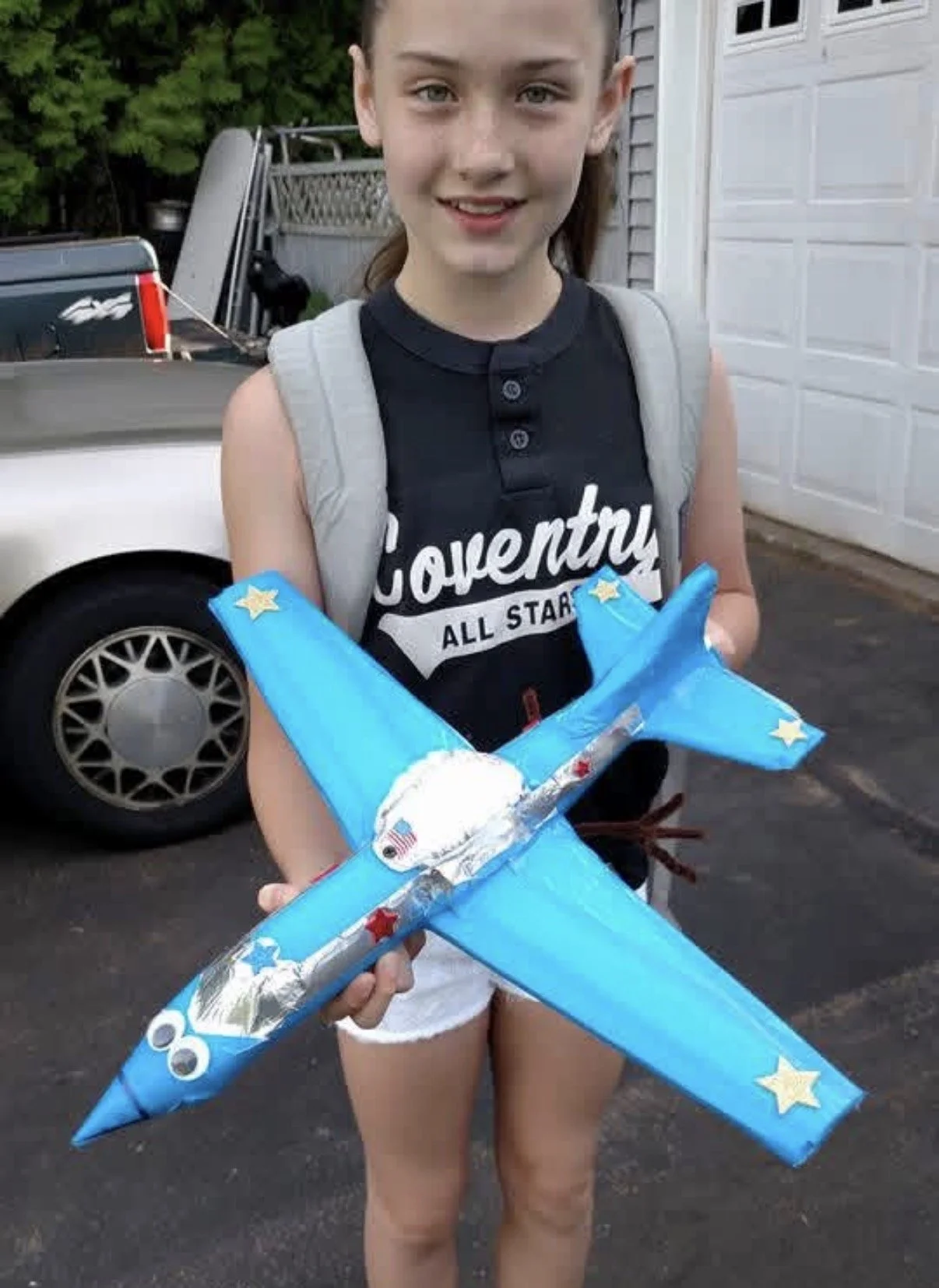 Young girl holding an airplane