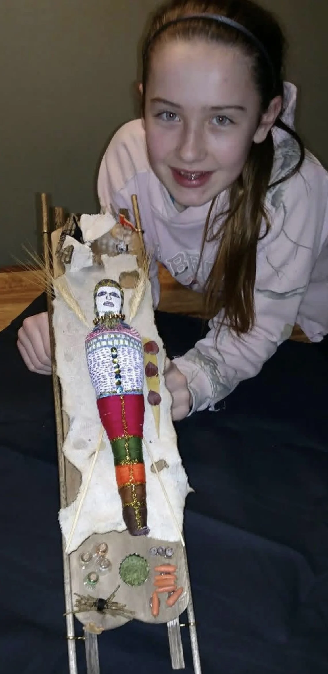 Young girl holding art project
