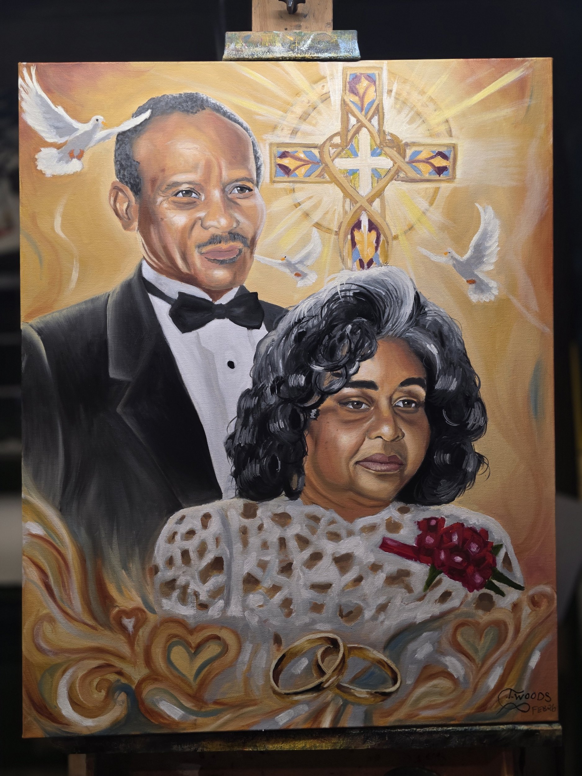 Painting of a man in a tuxedo and a woman in a white lace dress holding red flowers, with wedding rings in front. In the background, a cross with a decorative background, and doves flying around, with a warm color palette.