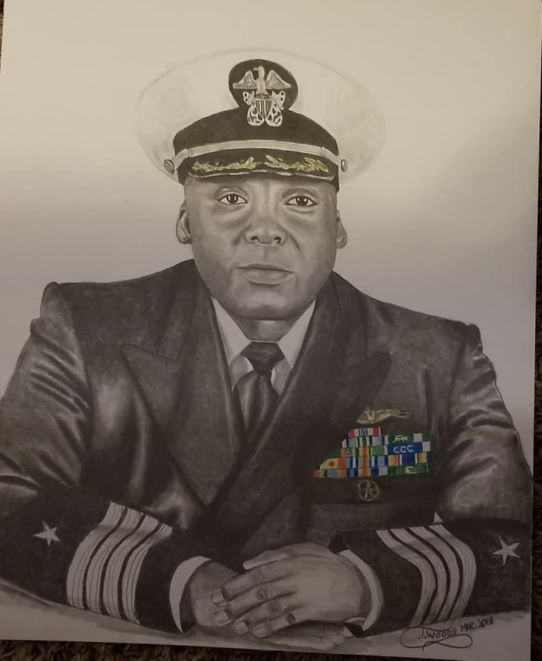 A detailed shaded portrait of a Black man in a military uniform by L. Woods, dated 2019. He is wearing a decorated officer’s jacket with medals, a tie, and a peaked cap with an insignia. His hands are clasped in front of him on a table.