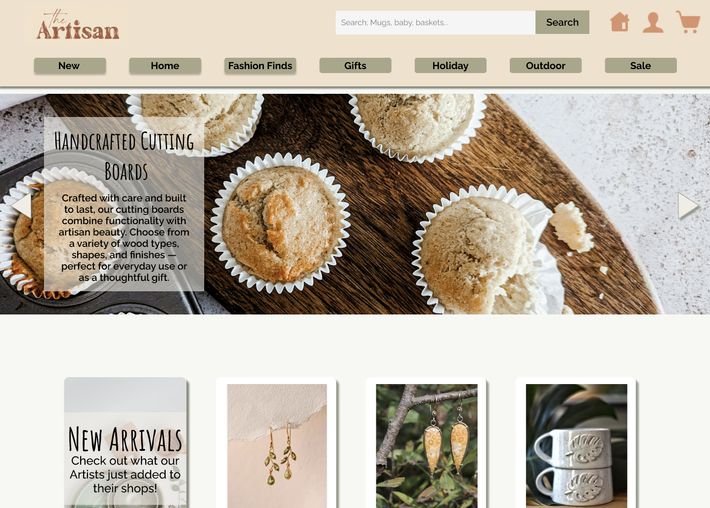 Screenshot of an online artisan marketplace website displaying baked goods and handcrafted items. The top part shows a navigation bar with categories like 'New,' 'Home,' 'Fashion Finds,' 'Gifts,' 'Holiday,' 'Outdoor,' and 'Sale.' Below, a large banner features cookies on a wooden tray with a text overlay promoting handcrafted cutting boards. Further down, there are sections highlighting new arrivals, including jewelry and ceramic mugs.