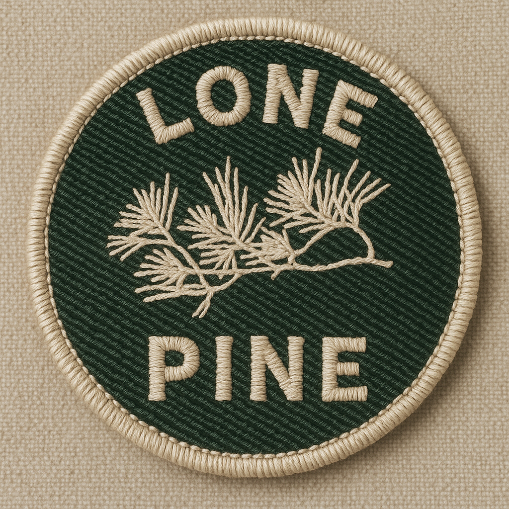 A round green embroidered patch with the words 'LONE PINE' and a pine branch in beige.