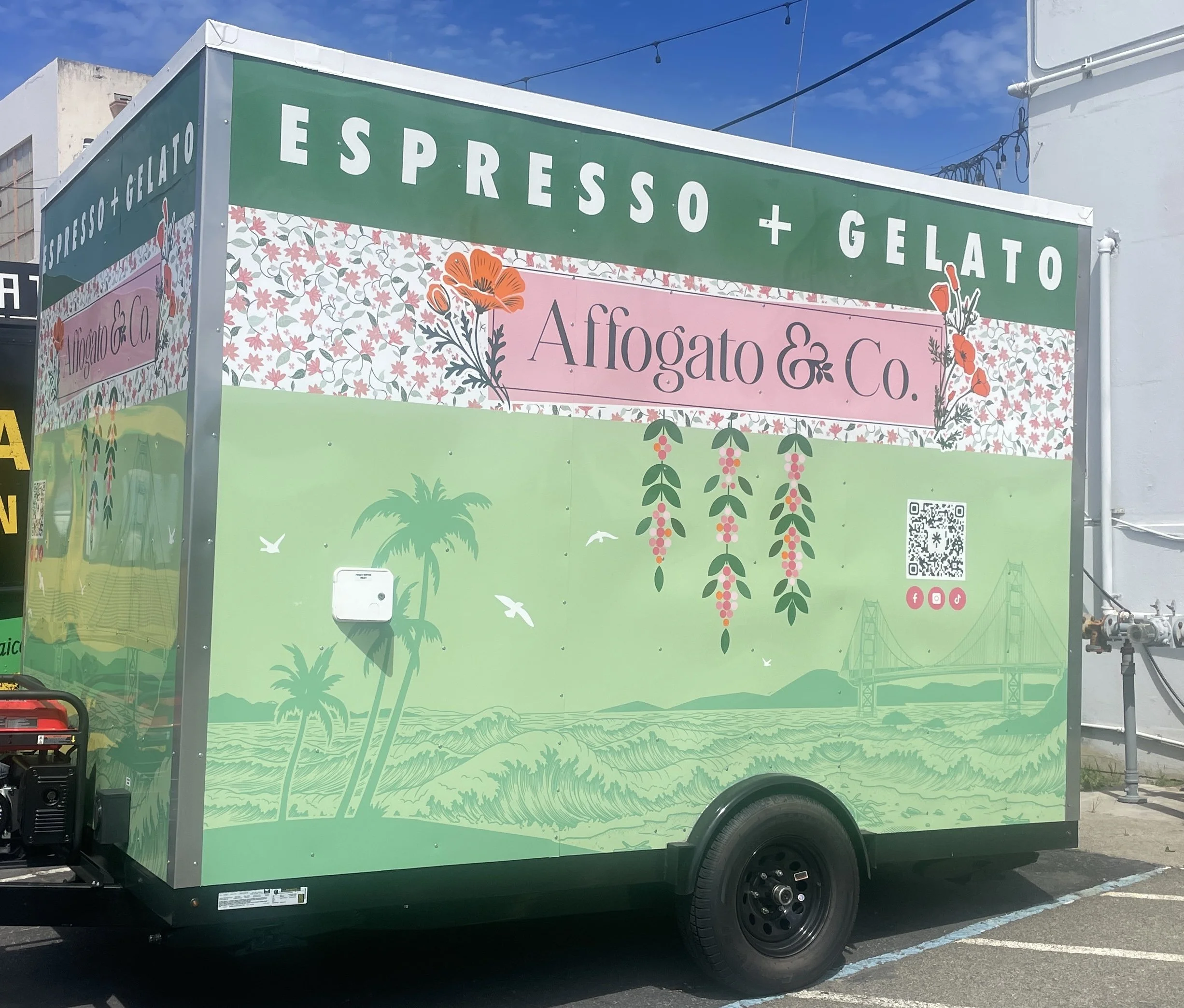 Food truck with green and pink decor featuring pineapples, flowers, a bridge, and palm trees, advertising espresso and gelato by Affogato & Co.
