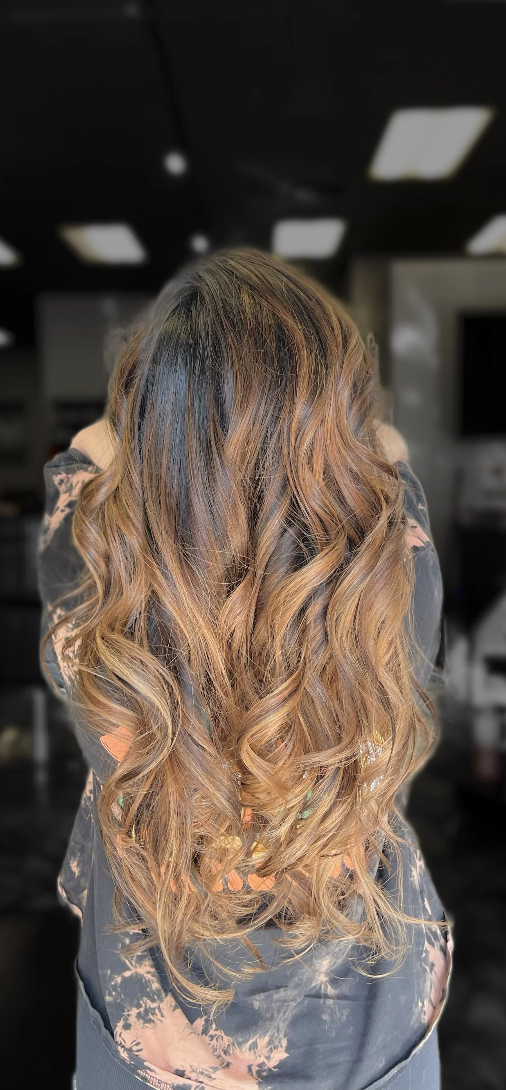 Caramel balayage and soft waves by hairstylist in Folsom California Long layered brunette hair with caramel highlights styled in soft waves, hair color by The Hair Duchess