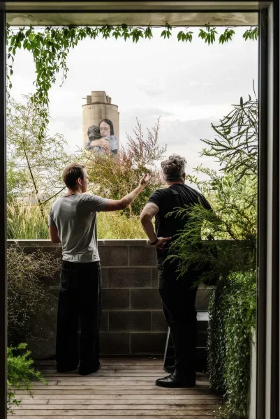 Two people on a planted balcony at Wurru Wurru Biik by Nightingale