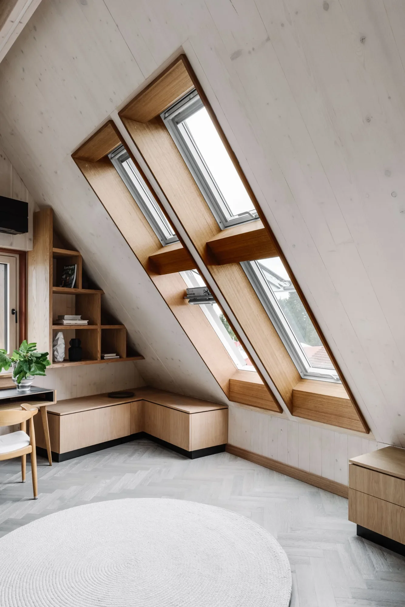Hutt Haus angled attic windows and built-in joinery after decluttering, now calm and uncluttered.