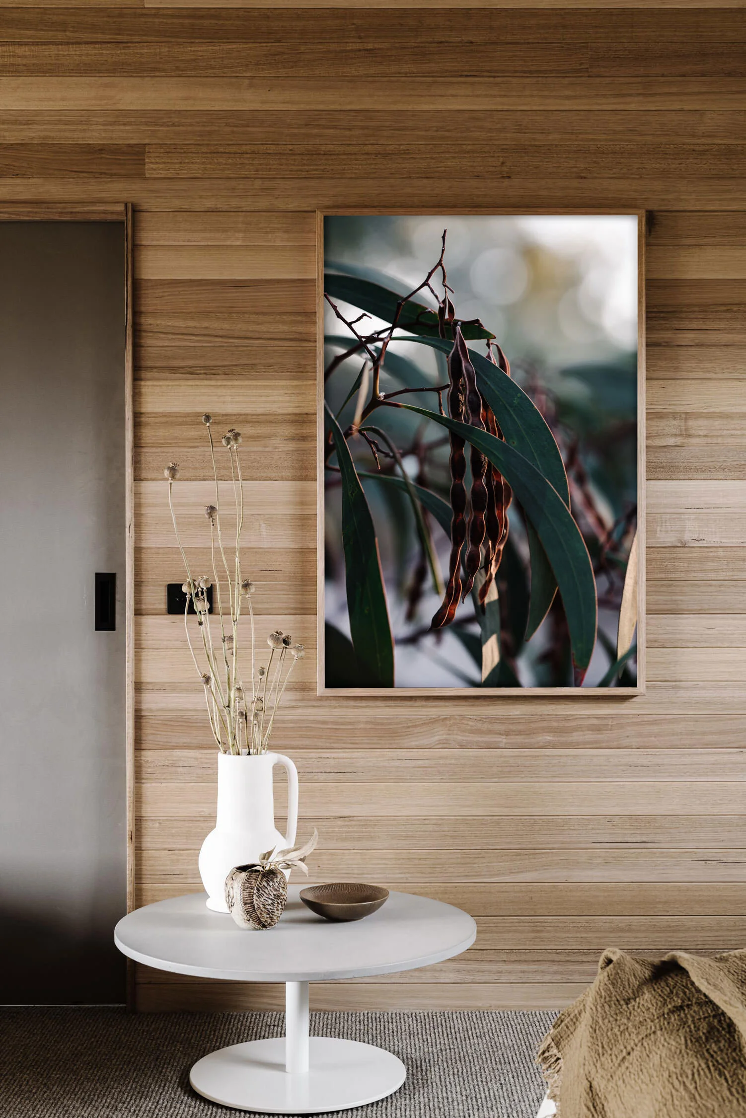 Seed Pods and Eucalyptus print in a timber-lined room