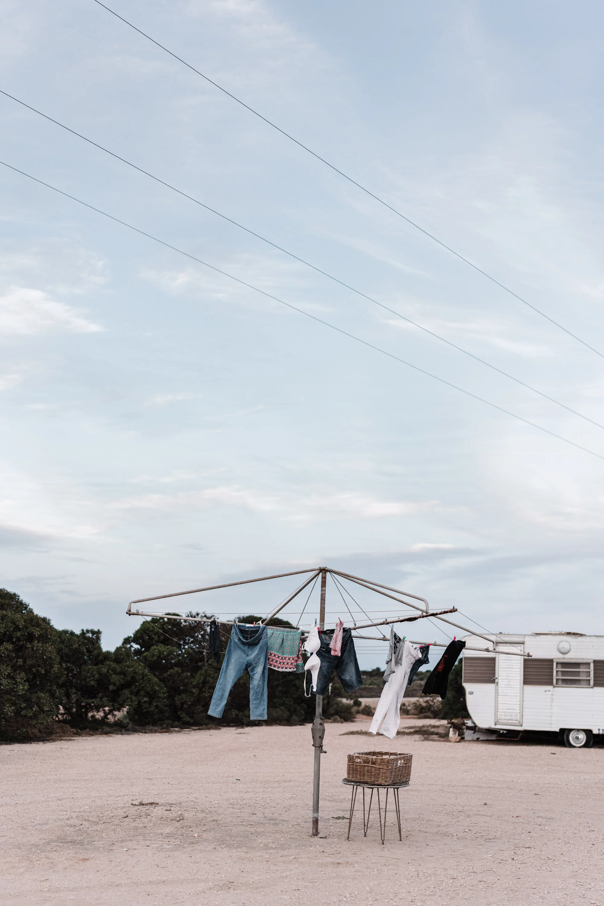 Washing line and caravan on a sandy campsite, fine art photograph