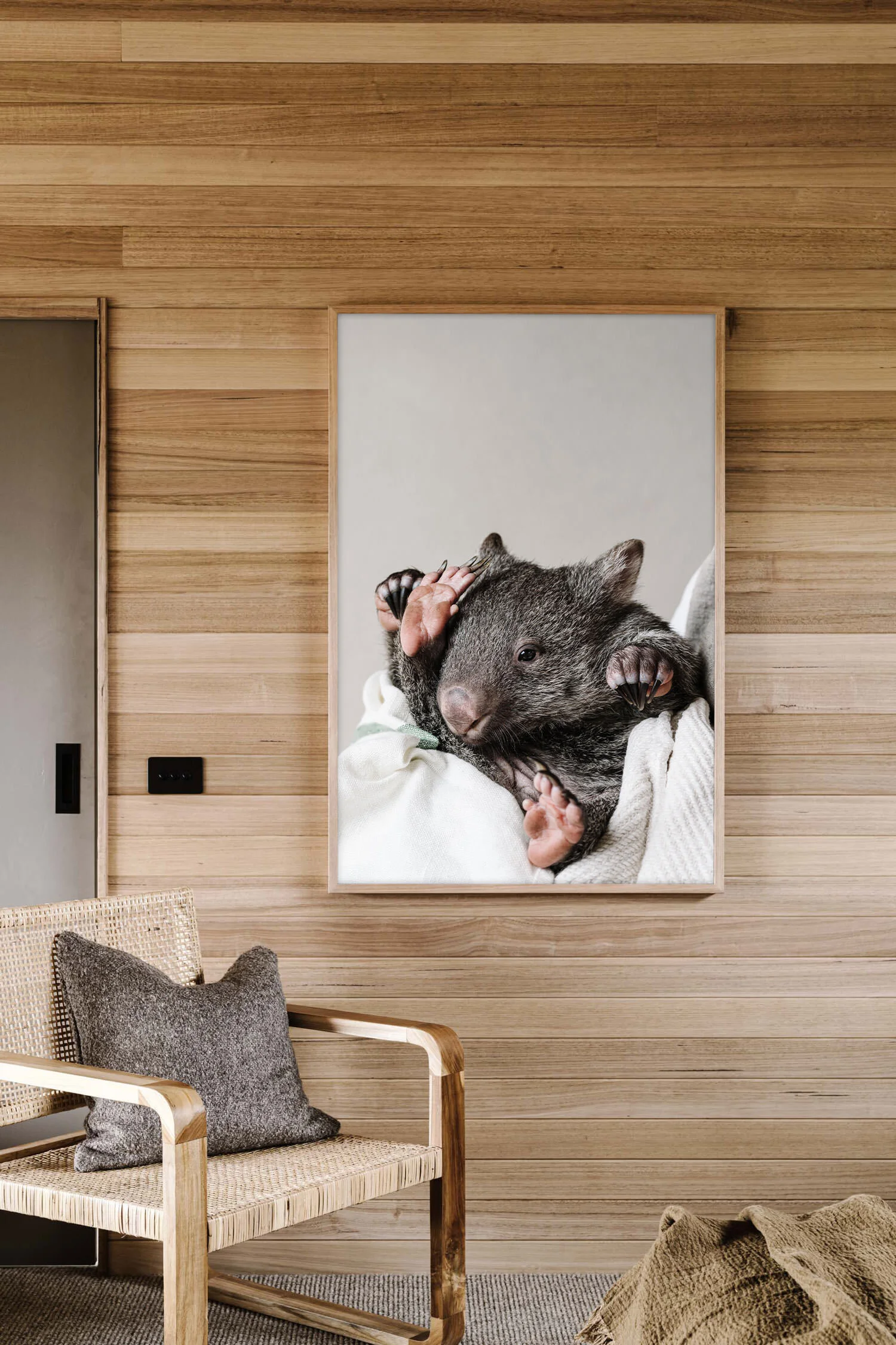 Kate the wombat print hanging in a timber-lined room