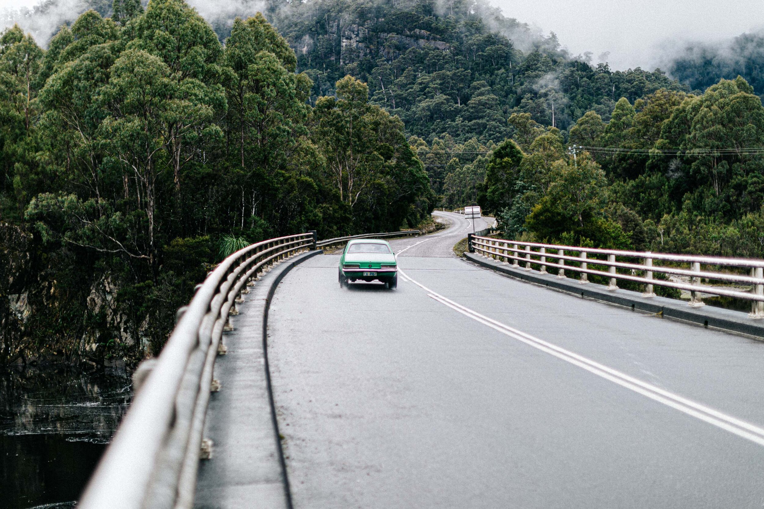 Car driving a bridge through rainforest on the road from Strahan, fine art photograph