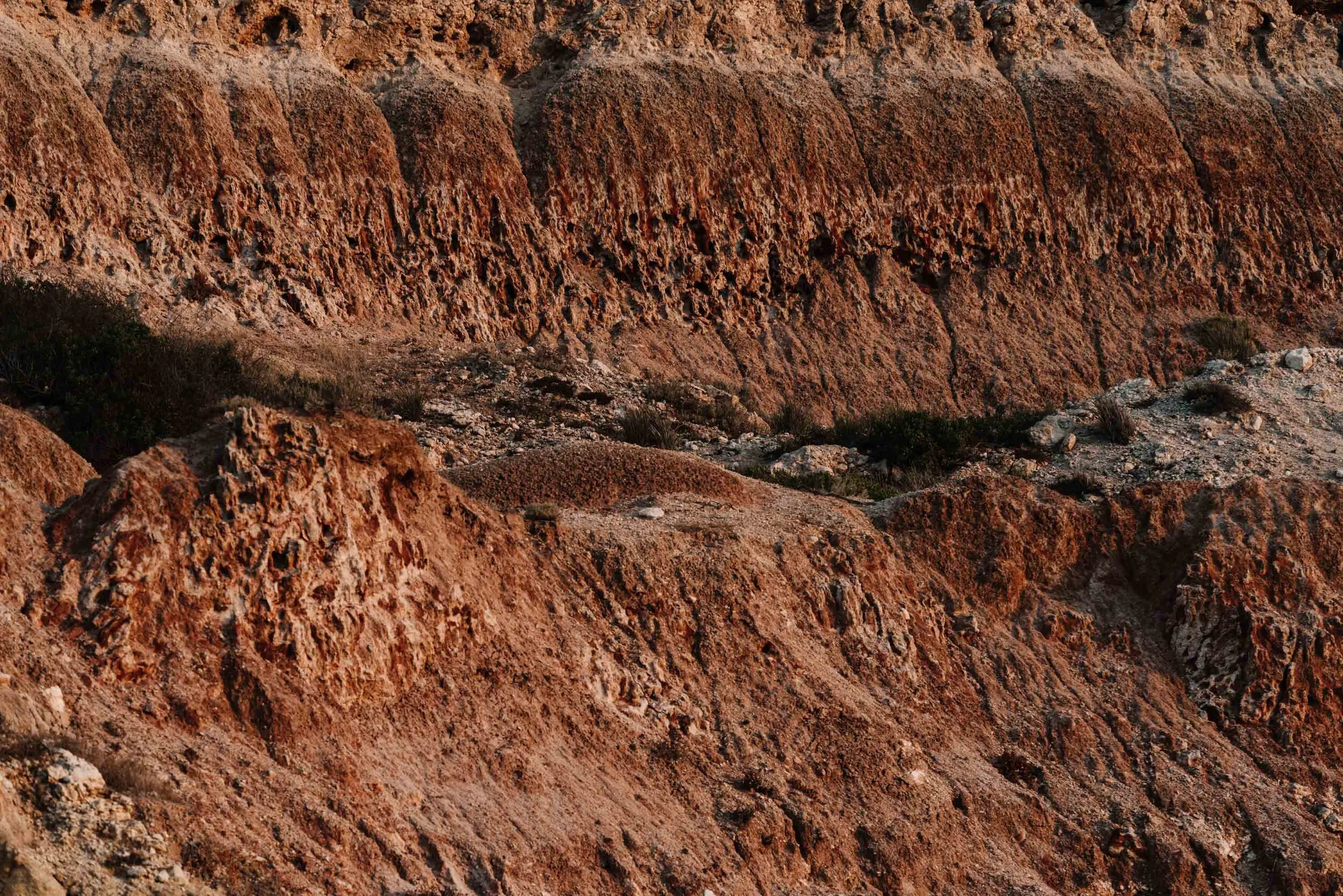 Eroded red earth cliffs, fine art photograph