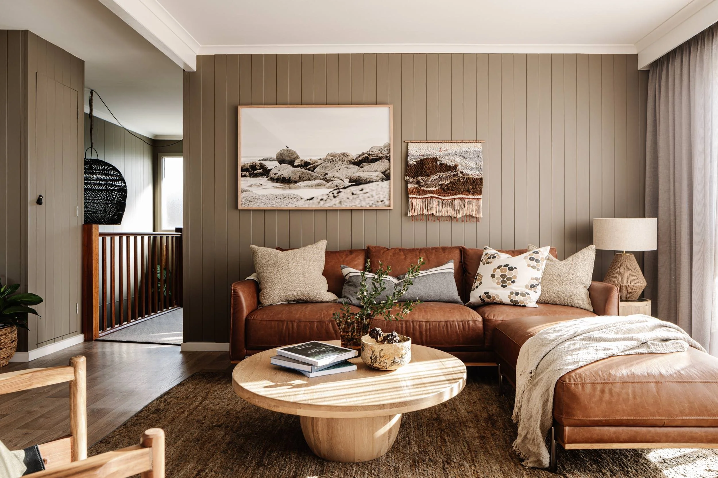 Oystercatcher, Whisky Bay print above a tan leather sofa