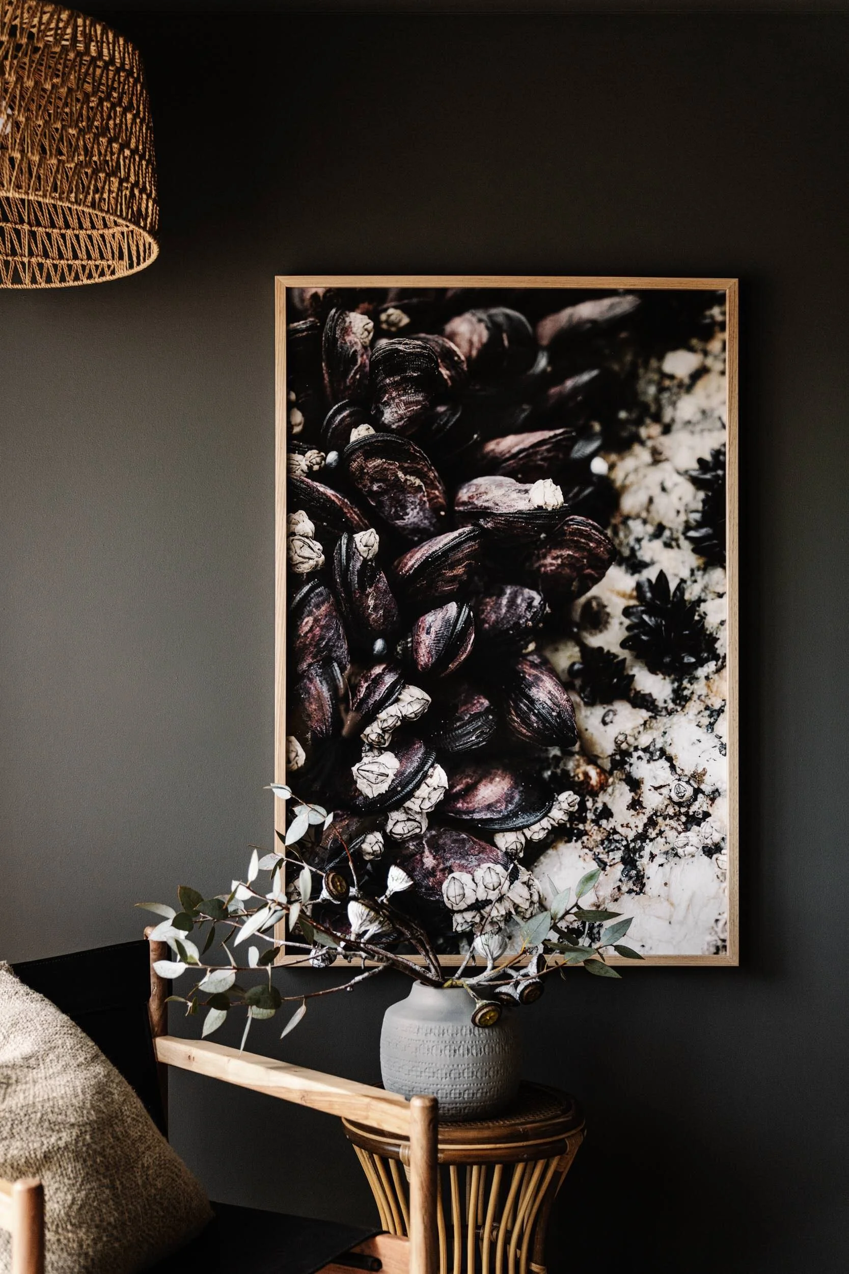 Very Shellfish print above a chair in a dark room
