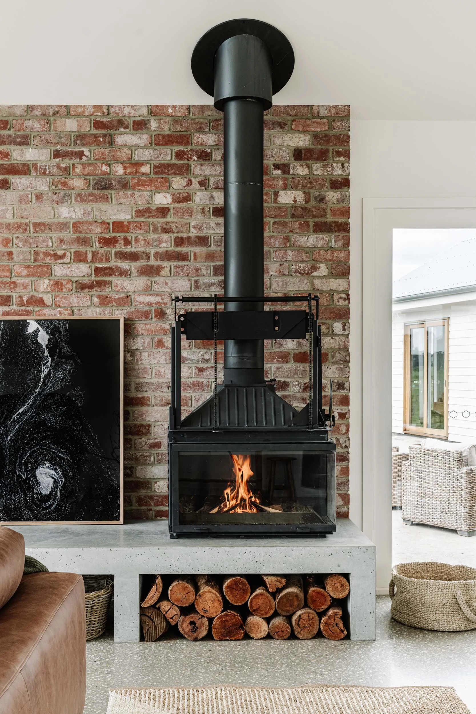 The Abyss print beside a wood fire and brick wall