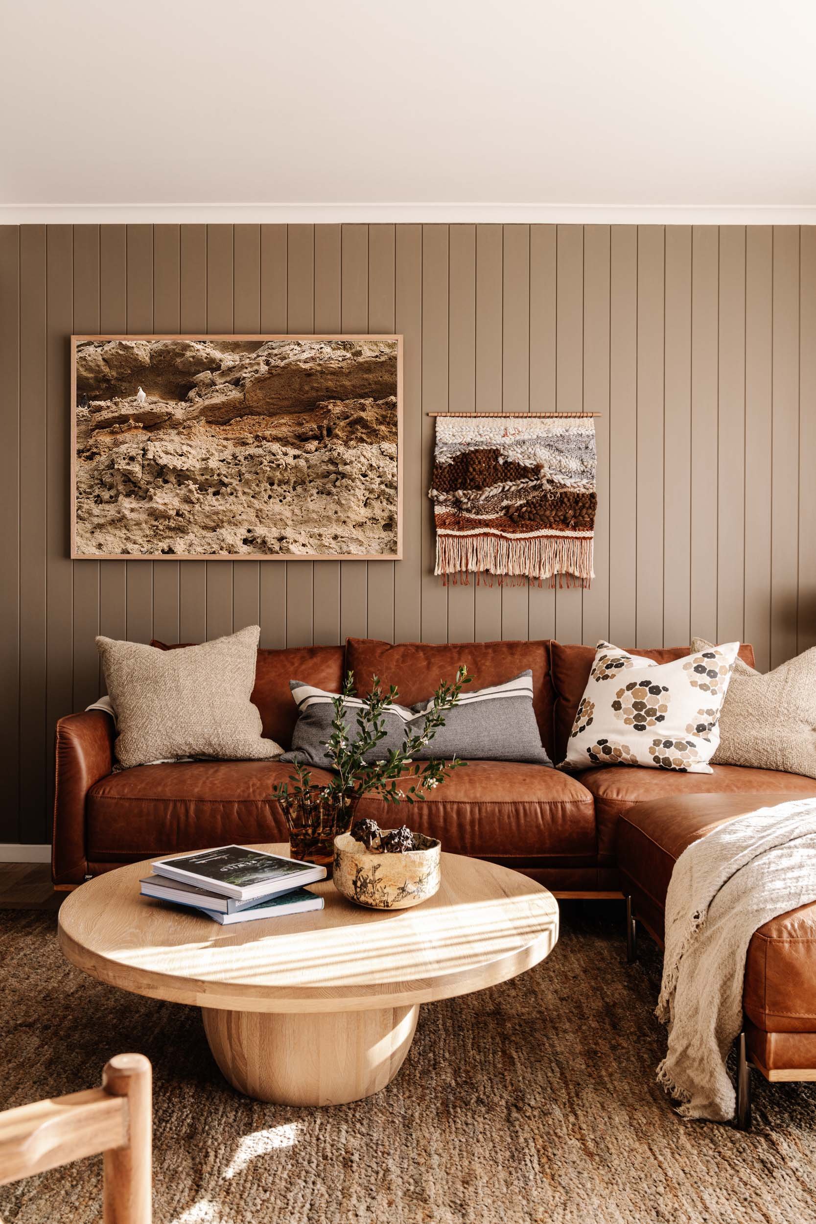 Pigeons of Port Willunga print above a tan leather sofa