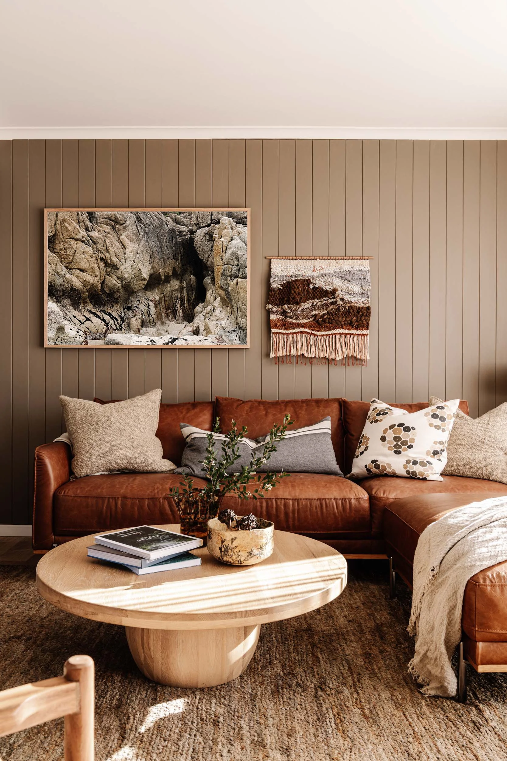Into the Cavern print above a tan leather sofa