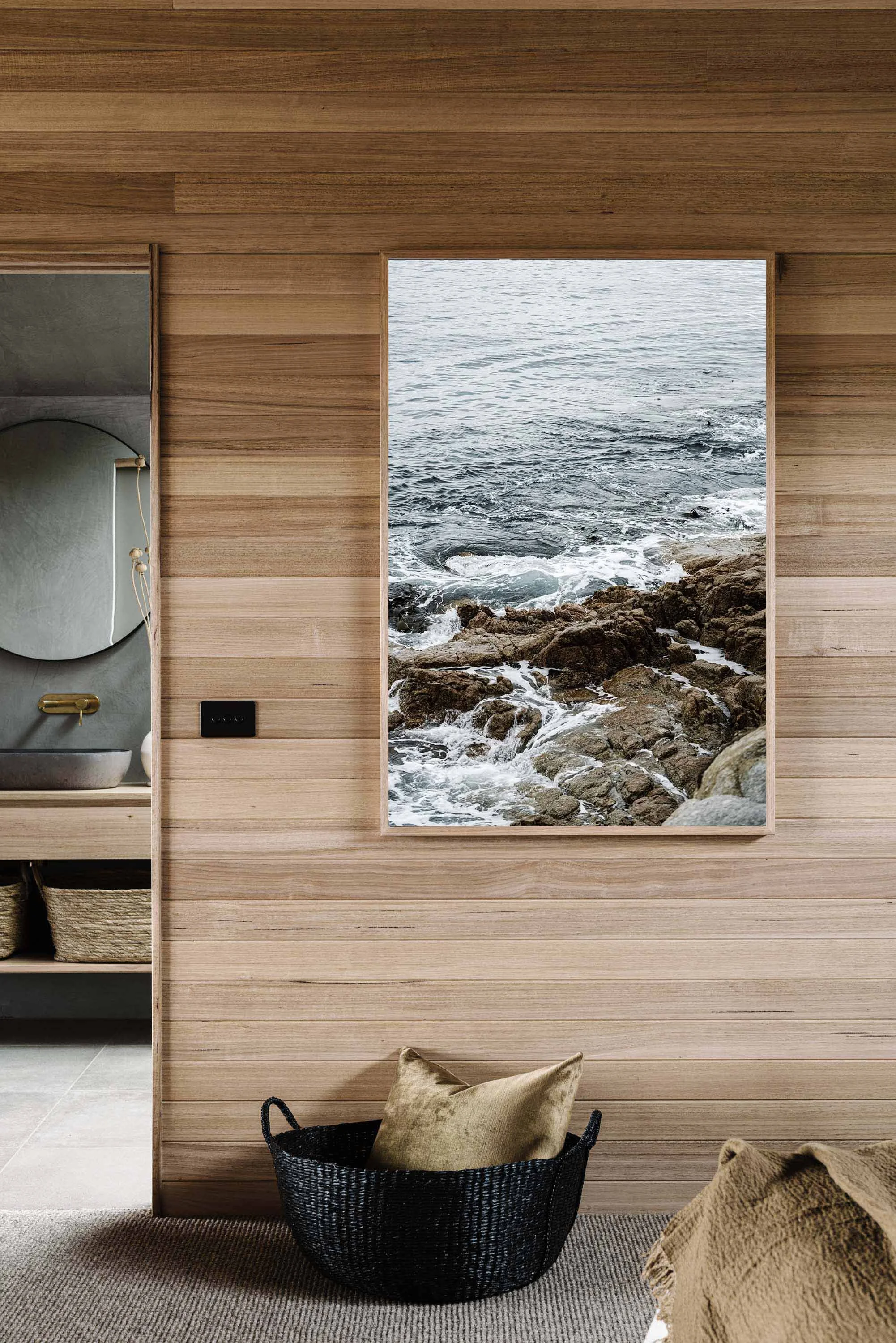 The Swirling Waters of Skeleton Bay print in a timber-lined room