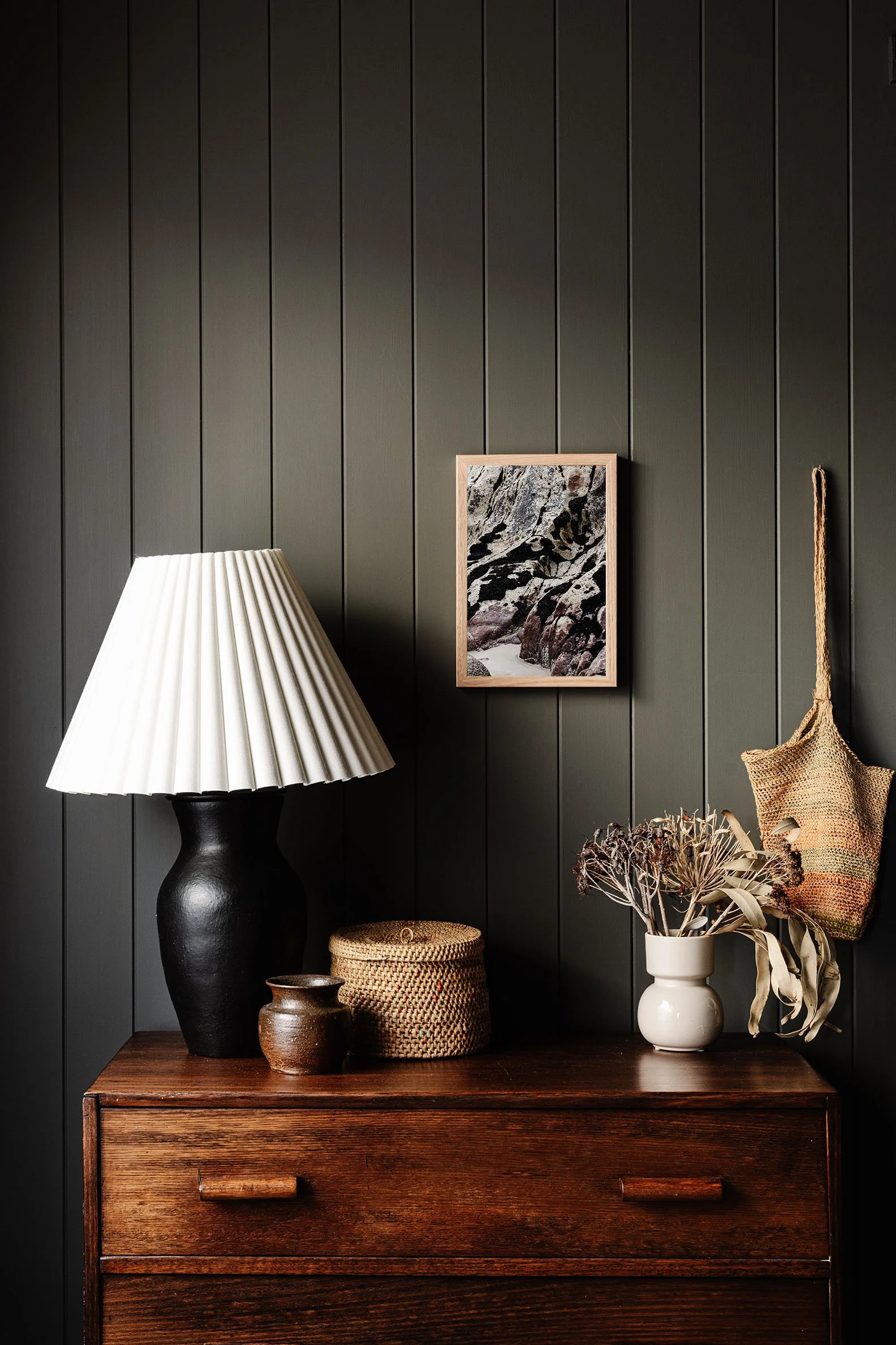 Dinosaur Toes print on a timber dresser beside a lamp