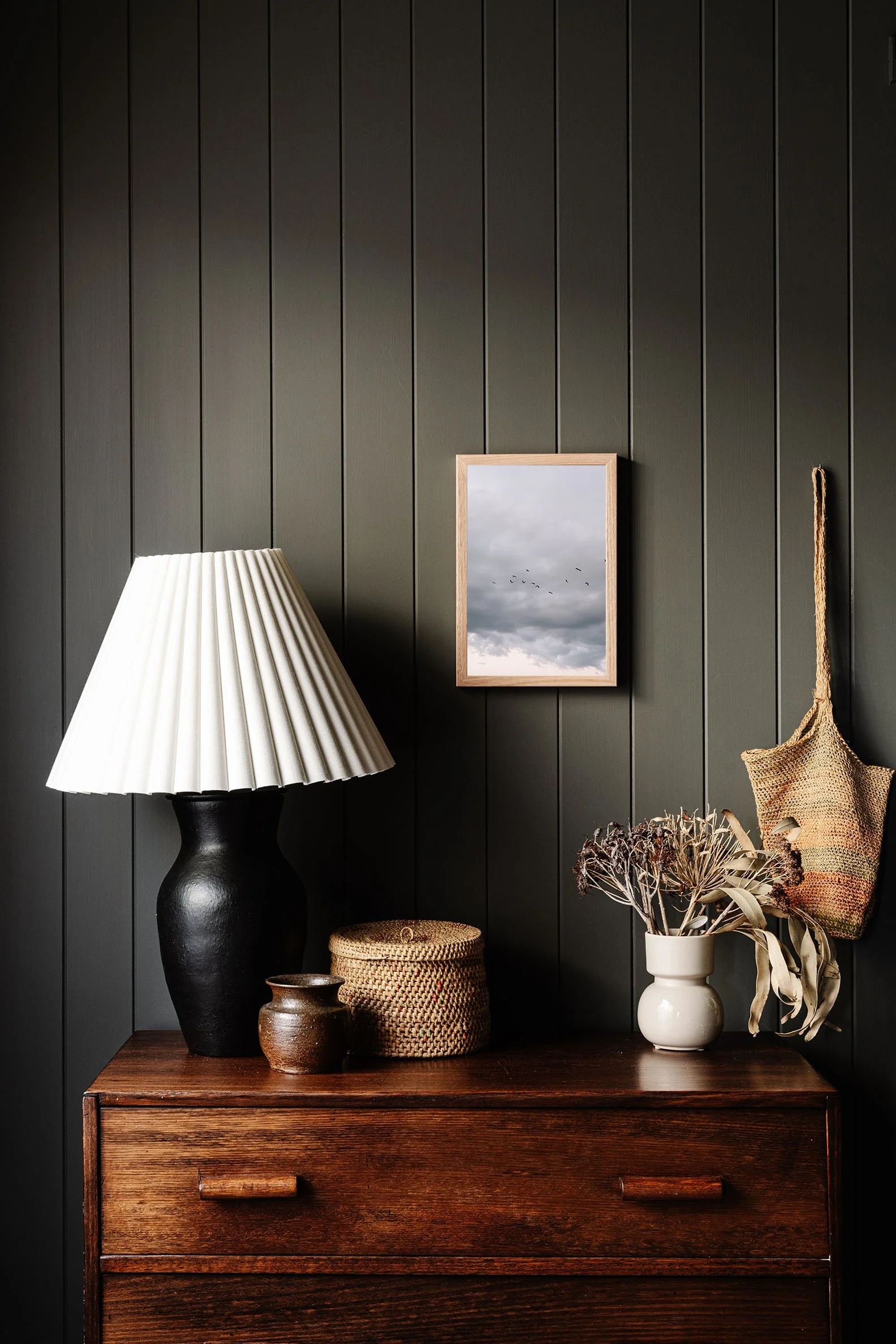 A Storm Is Coming, Broome print on a timber dresser beside a lamp