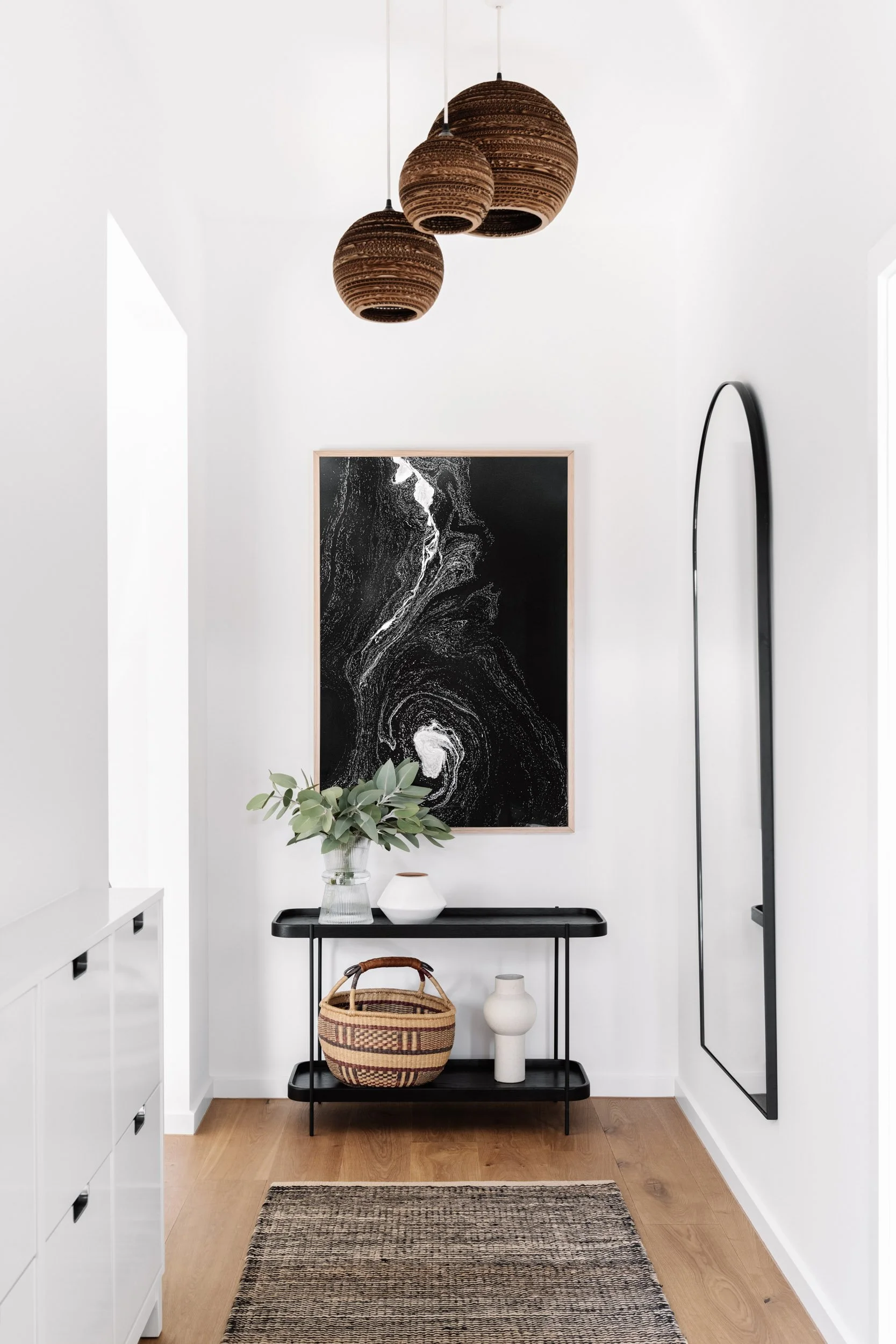 The Abyss print hanging in a white hallway