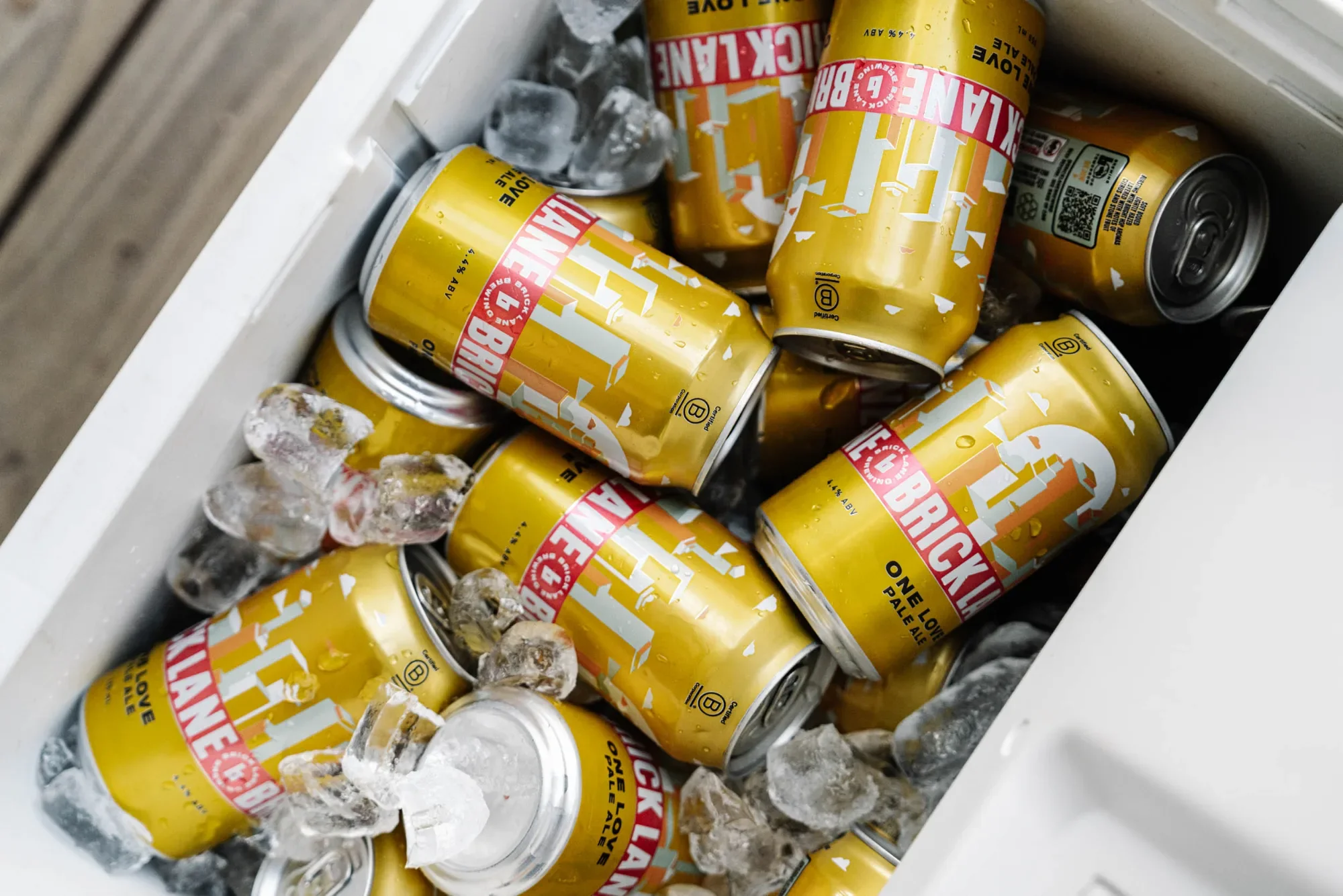 Cans of Brick Lane beer on ice in a cooler