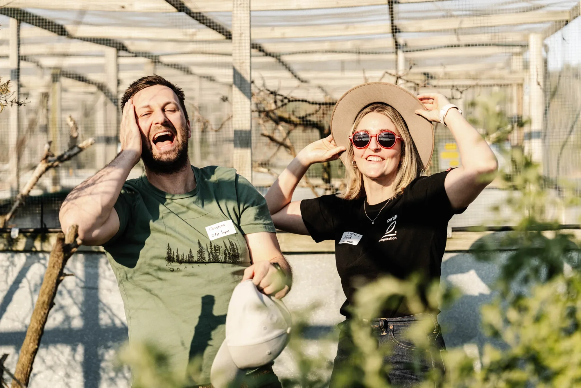 Two smiling visitors on the B Local Melbourne visit to Mt Rothwell, inside a netted enclosure.