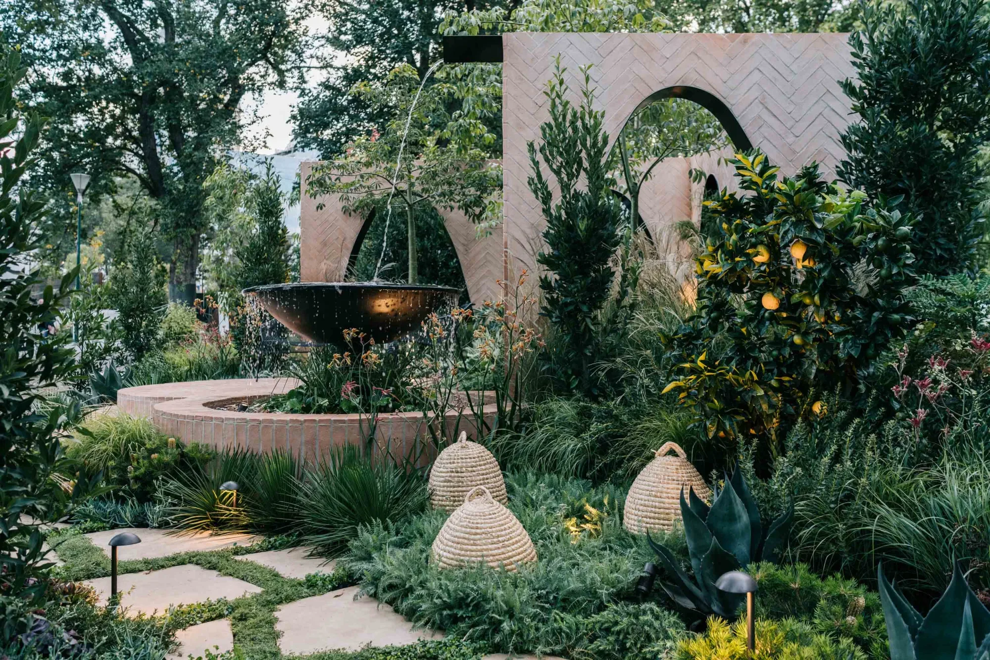 Garden at night with small, low-glare lights among native planting, showing wildlife-sensitive lighting.