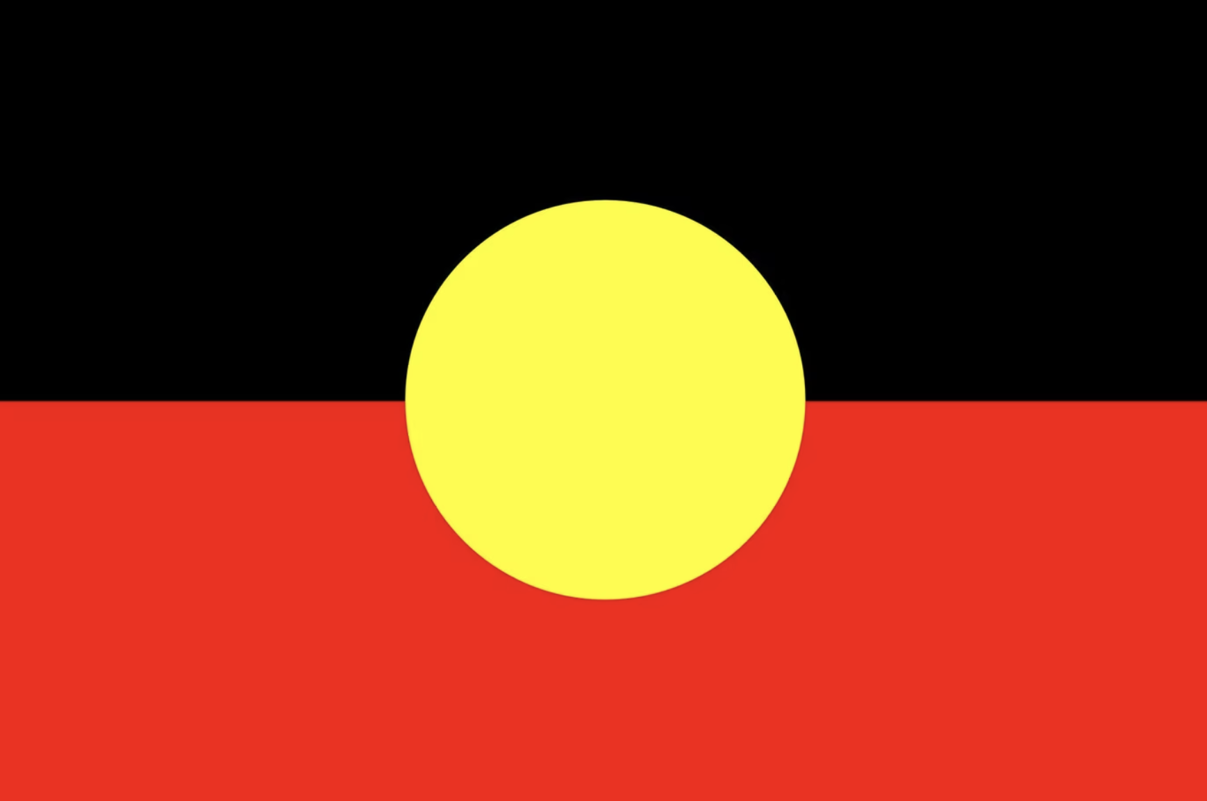 Flag of Australia with black, red, and yellow colors and a large yellow circle in the center.
