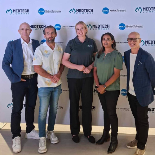 Five people standing together in front of a Medtech logo backdrop, posing for a photo at a professional event.