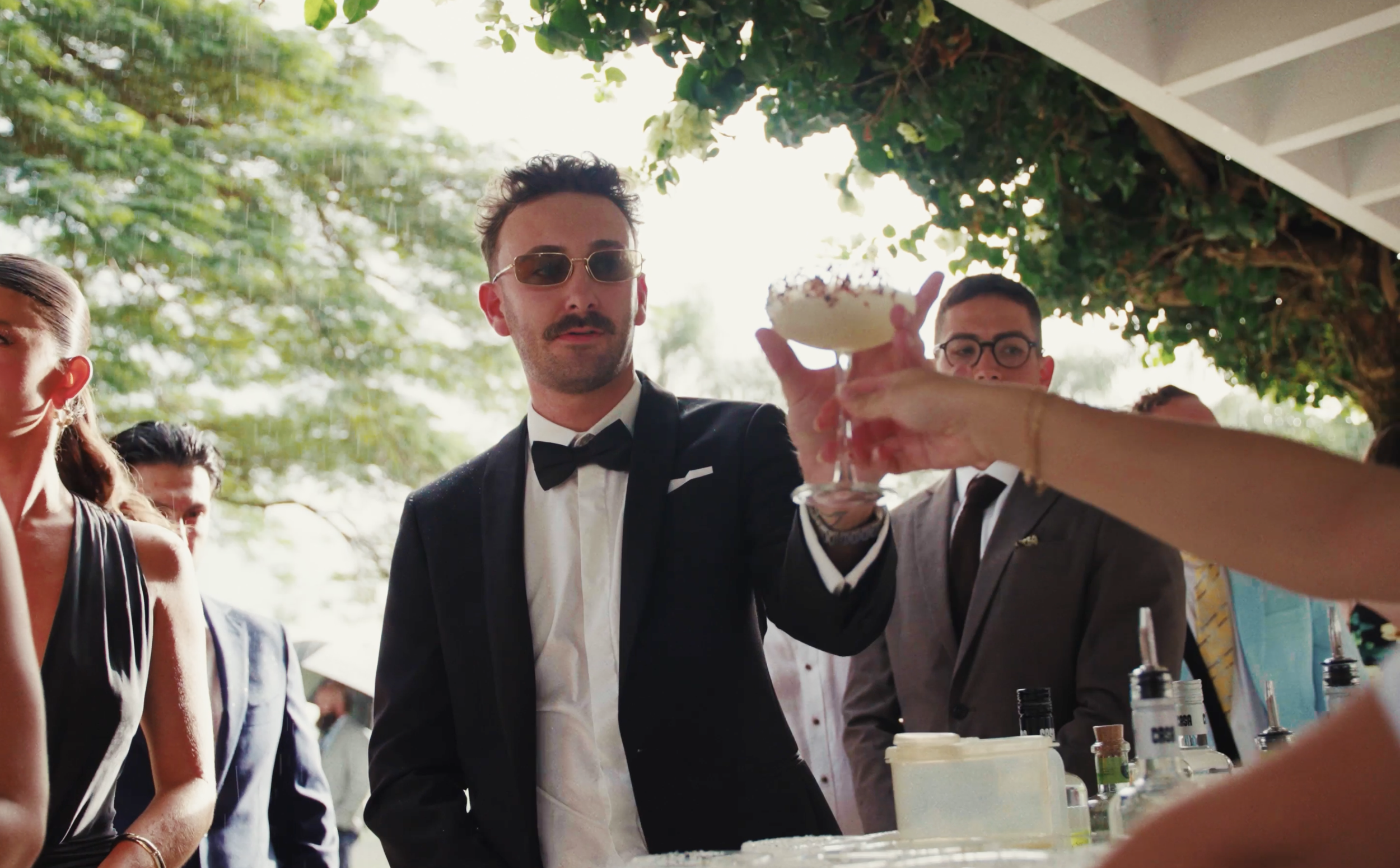 Man in tuxedo and sunglasses holding cocktail glass at outdoor event with people around
Mavis's Kitchen
Osteria Weddings
The Acre Boomerang Farm
Rosewood Estate
Cowbell Creek
Kwila Lodge
The Bower Estate
Sol Gardens
Hinterland House
The Calile Hotel