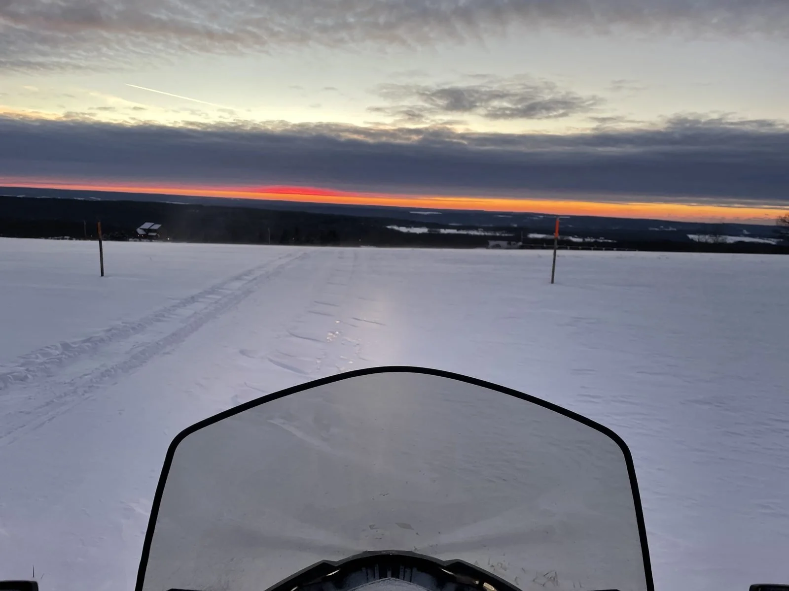 Snowmobile trail at sunset
