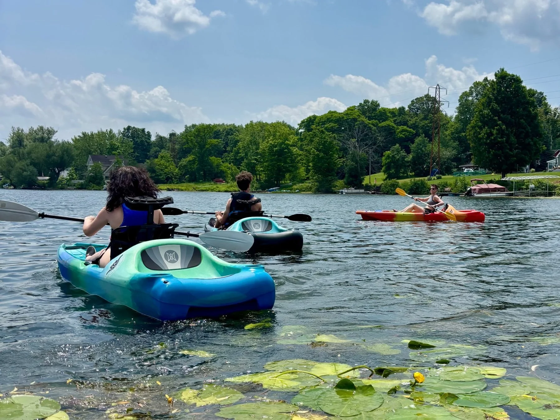Kayaks on Cassadaga Lake among lily pads