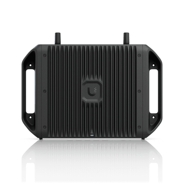 A black portable speaker with handles on each side and textured surface, featuring a logo in the center.