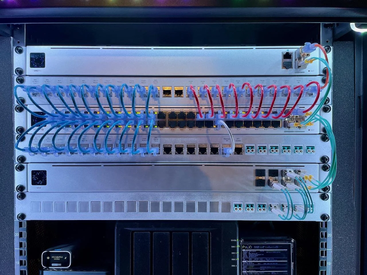 A network switch setup with multiple Ethernet cables connected, organized in a server rack.
