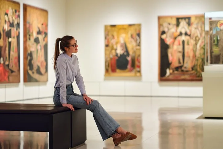 Woman looking at art, representing Arts & Culture in the For Purpose Sector