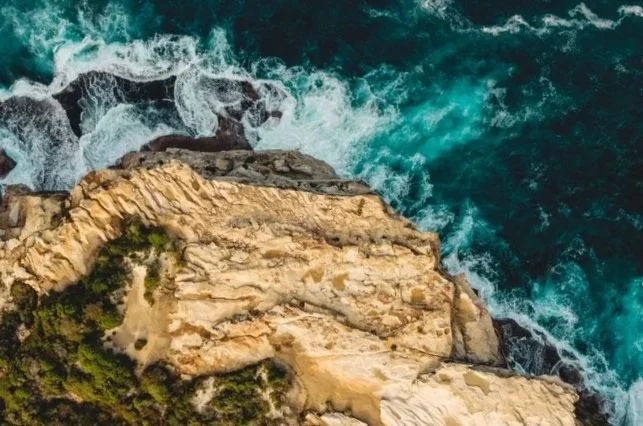 Natural rocky cliff meeting the ocean, Australian coastline