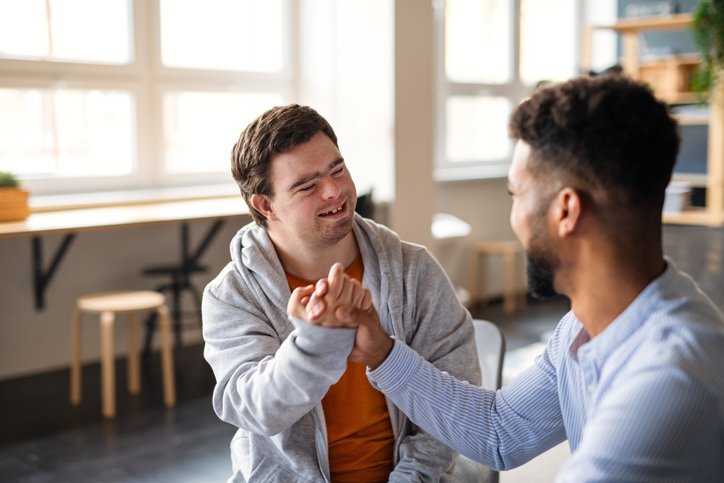 Man with special needs in a supportive embrace, representing Social Enterprise in the For-Purpose Sector
