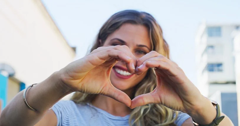 Woman showing a love heart, representing Charities in the For-Purpose Sector