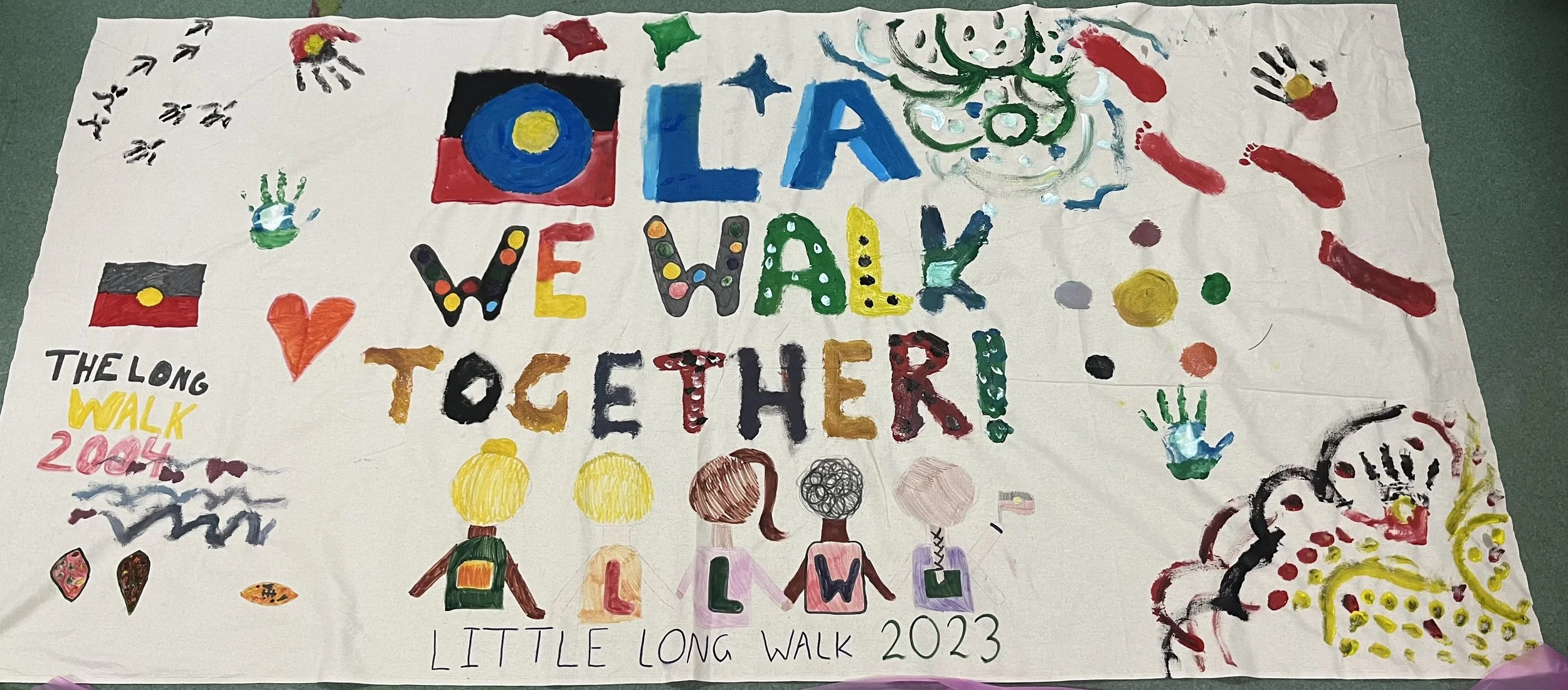 Colorful handmade poster with the words 'Colorado Walk Walks Together!' and 'LITTLE LONG WALK 2023' surrounded by hearts, handprints, abstract shapes, and various decorative designs.